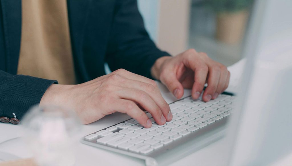 hands on a computer